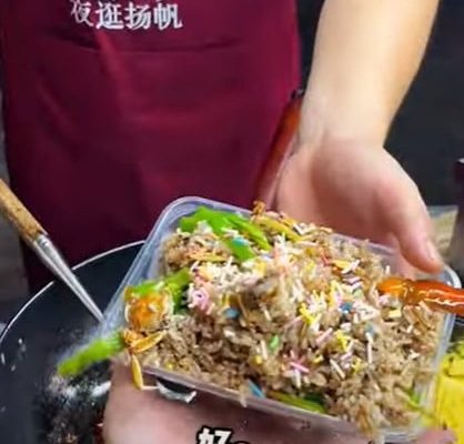Street hawker in China cooks fried rice with ice cream, tops it off with rainbow sprinkles